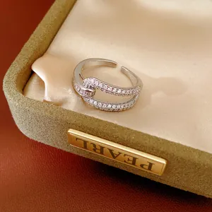 Detailed view of geometric hollow 18k gold plated ring set with sparkling cubic zirconia