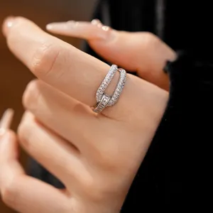 Close-up of 18k gold plated geometric open ring with shimmering zircons on hand