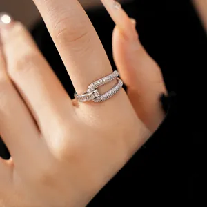 Macro detail view of an 18k gold plated geometric hollow open ring with sparkling zircons