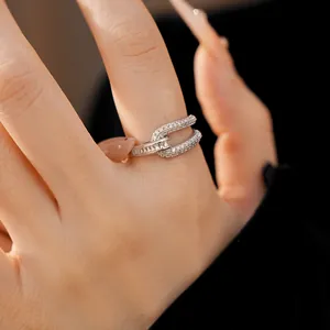Macro detail of 18k gold plated geometric open ring with sparkling zircon inlay.