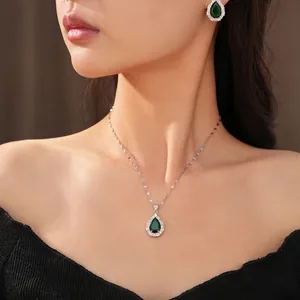 Elegant teardrop necklace and earrings set with green cubic zirconia