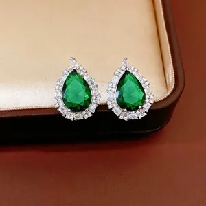 Elegant emerald green teardrop stud earrings with a sparkling cubic zirconia halo design