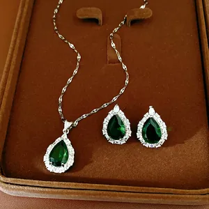 Close-up detail of emerald green waterdrop zirconia necklace and earrings set