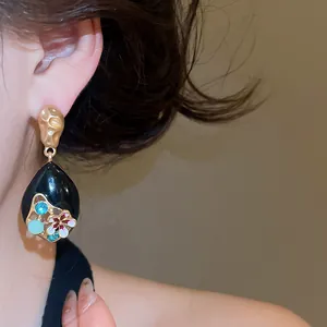 Detail of Monet Garden inspired vintage drop earring with floral oil-dripping design.