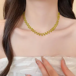 Detailaufnahme einer minimalistischen Halskette mit grünen Kristallperlen an einem Modell