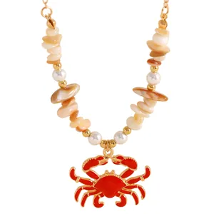 Close-up of beach style crab pendant necklace with seashell beads and faux pearls
