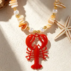 Close-up of vibrant red lobster pendant on Bohemian shell and pearl necklace.