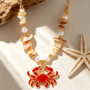Macro view of a red enamel crab pendant necklace with sea shells and imitation pearls