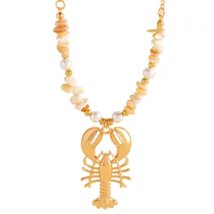 Detailed view of gold lobster pendant necklace with natural stone chips and faux pearls