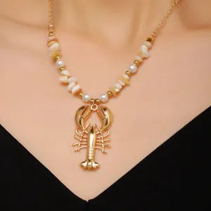 Exquisite close-up of a golden lobster pendant necklace with bohemian shell and pearl beads