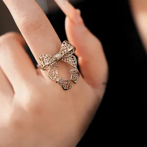 Macro detail of a vintage hollow bow-knot open ring showing intricate mesh texture