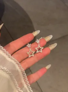 Exquisite detail of sparkling Korean style star drop earrings with zircon crystals