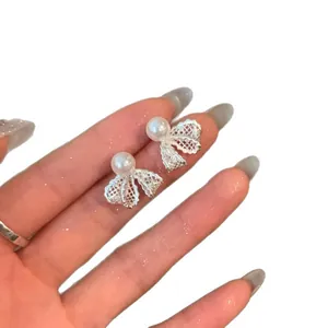 Elegant silver-tone lace mesh bow earrings with white pearl center for women stylish design