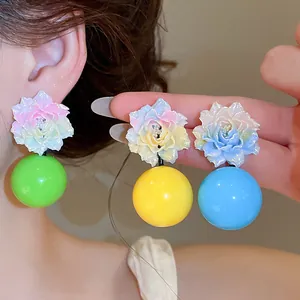 Detailed view of colorful resin flower earrings with vibrant round beads in dopamine style