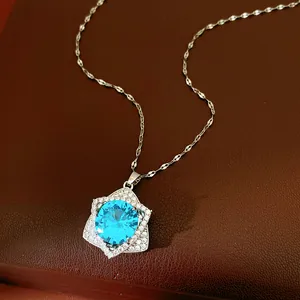 Detailed macro view of an exquisite star-shaped necklace with a sparkling blue zircon.