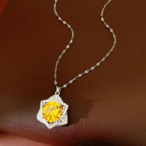 Close-up of shiny yellow zircon star pendant necklace resting on a leather background