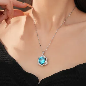 Elegant close-up of a sparkling blue zircon star necklace worn on a model's neck