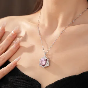 Detailed view of an elegant sparkling pink zircon star pendant necklace on model