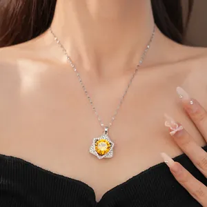 Detail shot of a star pendant necklace with a brilliant yellow zircon center