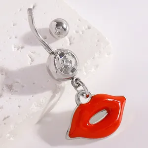 Macro detail of silver navel ring with crystal and vibrant red lip charm