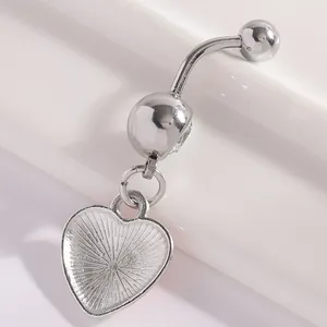 Close-up of a silver-colored navel ring featuring a textured heart-shaped pendant.