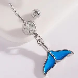 Close-up of blue enamel mermaid tail navel ring with sparkling clear gemstone detail.