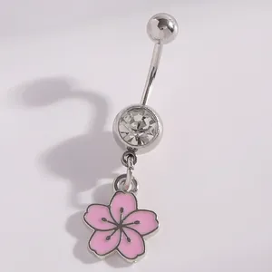 Close-up of pink cherry blossom belly button ring with clear zircon crystal