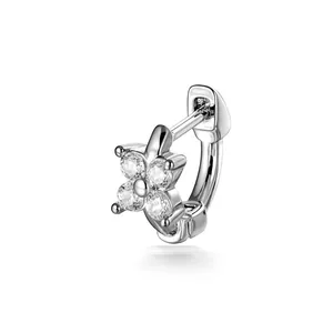 Silver-tone tiny hoop earring with four-petal zircon flower design on white background