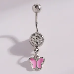 Close-up detail of silver navel piercing featuring a pink enamel butterfly dangle