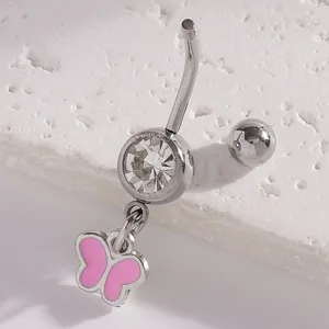 Macro detail of a pink butterfly pendant navel ring featuring a sparkling cubic zirconia.