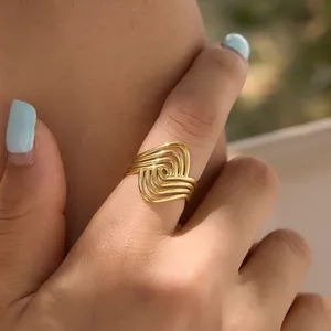 Detailed macro shot of a gold geometric linear spiral ring made of stainless steel