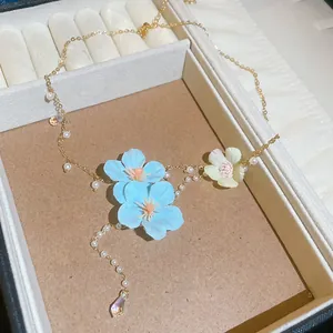Detail of fabric flower necklace with pearls and crystal beads in a jewelry box