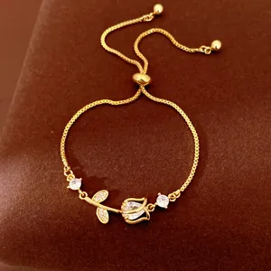 Detailed shot of an adjustable gold tulip bracelet featuring sparkling zircon stones.