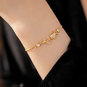 Close-up detail of an elegant gold tulip bracelet with zircon crystals on a wrist.