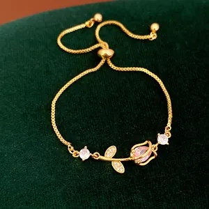 Close-up of elegant gold tulip bracelet with pink zircon and adjustable sliding clasp