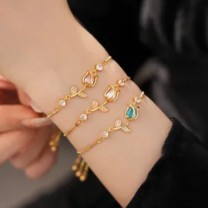 Detailed view of elegant gold-toned tulip bracelets featuring colorful zircon stones
