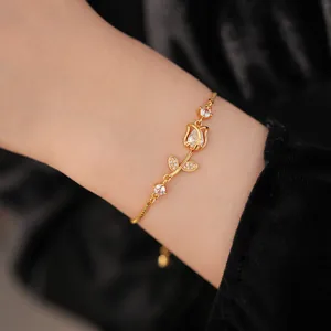 Close-up of elegant gold tulip bracelet with zircon stones and adjustable chain
