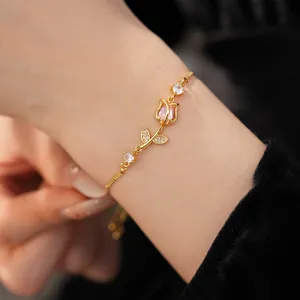 Detailed close-up of a gold tulip bracelet featuring pink zircon and micro-inlaid stones