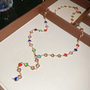 Close-up of colorful heart crystal Y-shaped necklace on premium jewelry tray