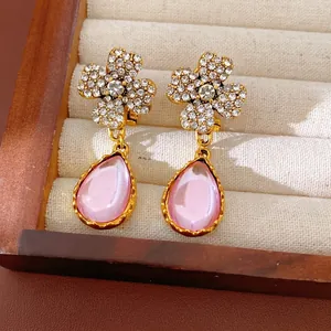 Elegant vintage gold plated earrings featuring crystal flower tops and pink resin teardrops