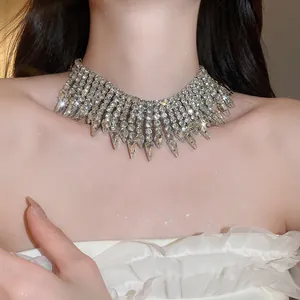 Detailed view of a luxury silver rhinestone teardrop fringe choker necklace on a model's neck