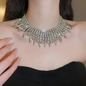 Detailed view of luxury silver rhinestone teardrop tassel necklace worn by model
