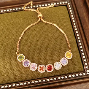 Detailed view of adjustable gold bracelet with colorful square cubic zirconia stones