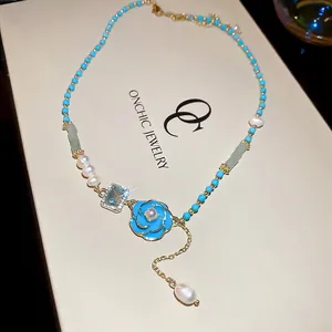 Elegant freshwater pearl necklace with blue enamel flower and turquoise beads