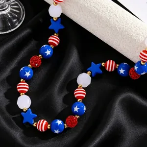 Detail of red white and blue beaded necklace with gold spacers and star-shaped charms