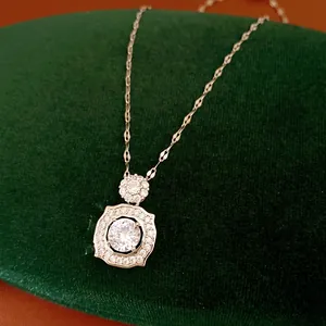 Detailed close-up of a sparkling zircon geometric pendant on a silver chain