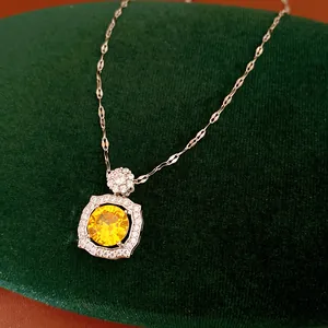 Detailed macro shot of an elegant square yellow zircon pendant on a silver chain