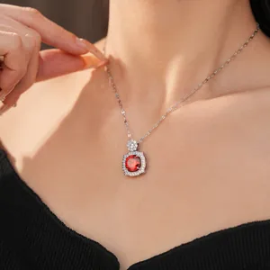 Exquisite silver-tone necklace featuring a brilliant red zircon pendant macro view
