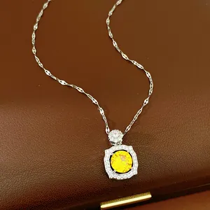 Macro detail of elegant square pendant with a sparkling yellow round zircon stone