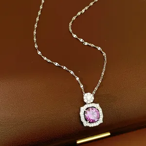Detail shot of purple zircon pendant necklace with silver frame on leather background